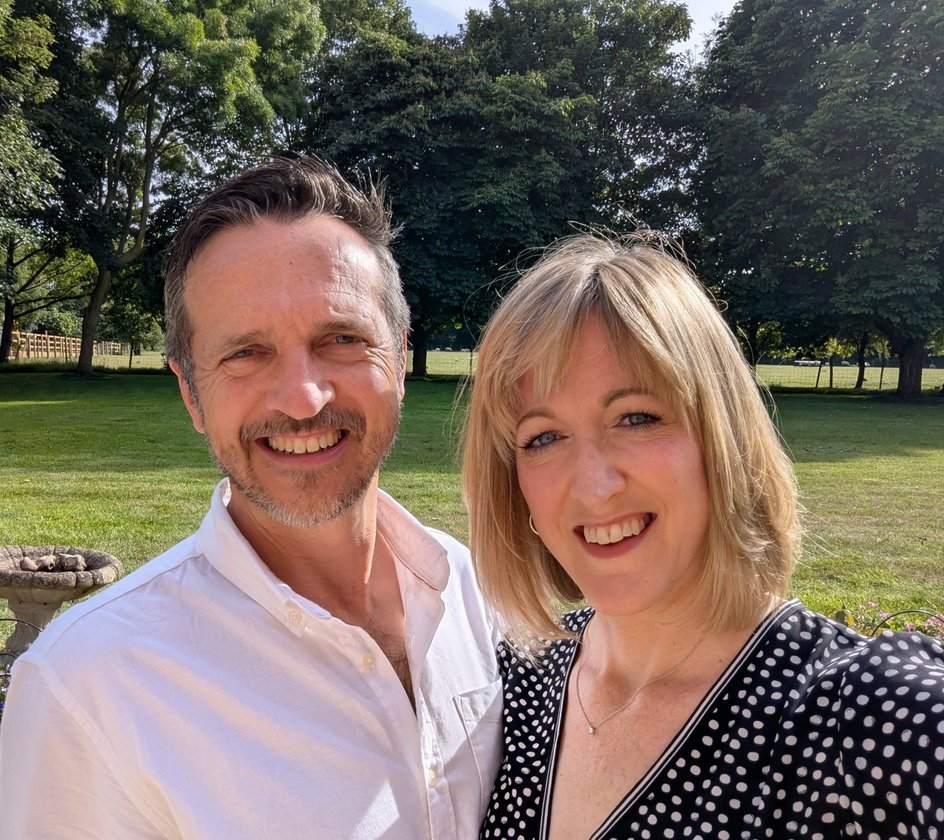 Simon and Jo smiling together on the plot in the Kent Downs