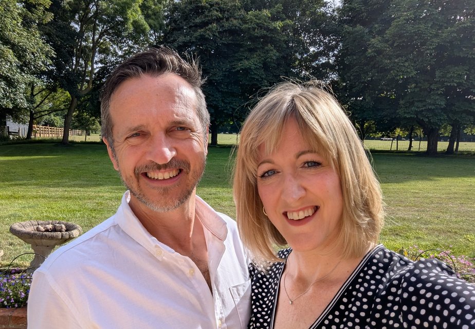 Simon and Jo smiling together on the plot in the Kent Downs