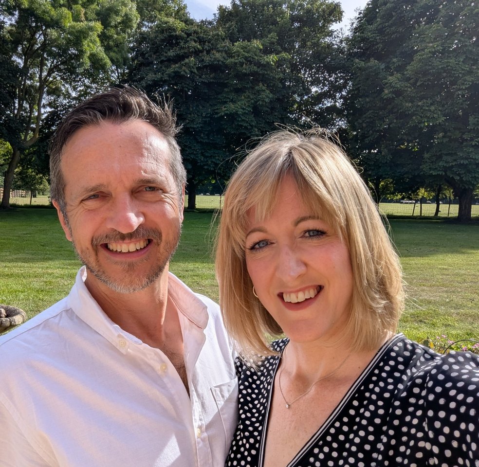 Simon and Jo smiling together on the plot in the Kent Downs